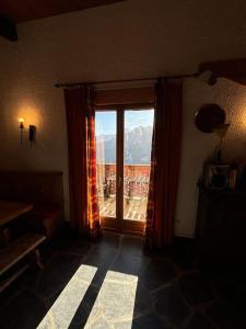 a room with a window with a view of a mountain at Chalet de l'Ours - Pla d'Adet in Cadeilhan-Trachère
