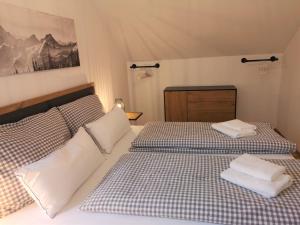 Tauplitz Panorama Apartment, 75qm, Balkon und Sauna في توبليتز: غرفة نوم بها سريرين مع مناشف عليهما