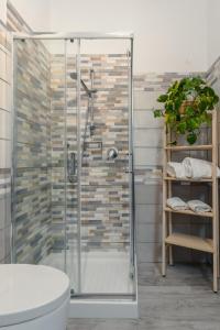 a bathroom with a glass shower and a toilet at Vista mare AirPort in Fiumicino