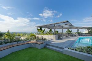 a house with a swimming pool and a patio at Loxwood House Apartments in Accra