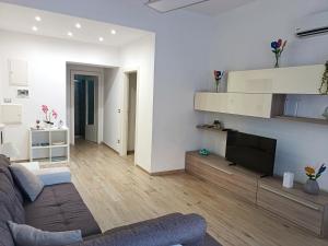 a living room with a couch and a tv at Casa Vergara Piazza Mazzini in Lecce