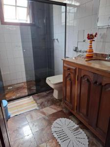 a bathroom with a shower and a toilet and a sink at Hostel do Mirante in Ouro Preto +25 photos