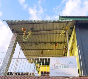awning over a building with flowers on it at DZ Homestay 1BHK in Dimāpur