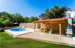 a backyard with a pool and a gazebo at Awesome Home In Krk With Wifi in Risika