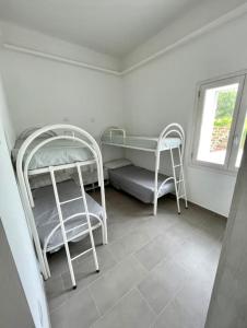 a room with two bunk beds and a window at Villa Nido dei Passeri in Calasetta