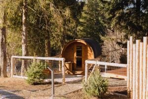 a small cabin with a door in the woods at The Sopa - heritage premium houses in Zakopane