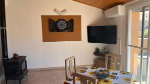 a dining room with a table and a dartboard on the wall at CA LIDIA-Apartamentos Turísticos EL CAMPANAR 1 in Benimantell +15 photos