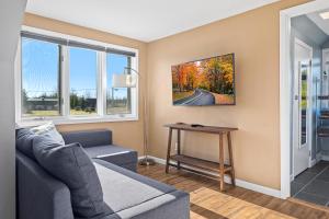 a living room with a couch and a table at Bird's Nest - Above Bakery Cozy Studio, Perfect for Couples! in Sister Bay