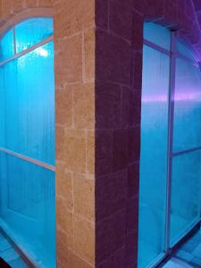 a building with two windows and a brick wall at Apulia Relax Room in Manduria
