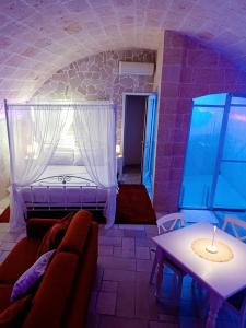 a living room with a couch and a window at Apulia Relax Room in Manduria