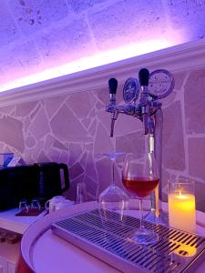 a bottle of wine and two glasses on a table at Apulia Relax Room in Manduria +46 photos