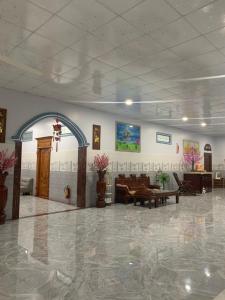 a lobby with couches and tables in a building at Nhà Nghỉ Liên Hòa in Ha Tien