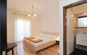 a small bedroom with a bed and a bathroom at Holiday Home Pakostane 25 in Pakoštane