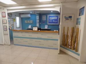 a counter in a room with a blue wall at Hostal Villa Maruja in El Arenal