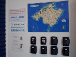 a sign with a map on it next to a keyboard at Hostal Villa Maruja in El Arenal