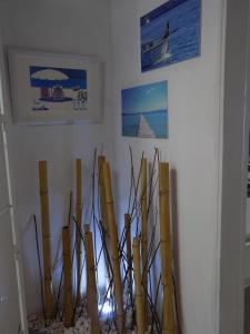 a vase filled with bamboo sticks on a wall at Hostal Villa Maruja in El Arenal
