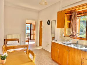 a kitchen with a table and a dining room at Marinos Studios and Apartments in Gialiskari +37 photos