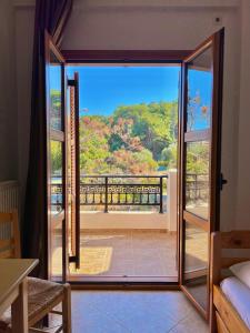 an open door to a balcony with a view at Marinos Studios and Apartments in Gialiskari