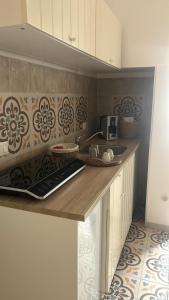 a kitchen with a counter top with a sink at Vicolo 4 Locazione Turistica in Monopoli +2 photos