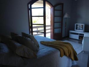 Giường trong phòng chung tại Casa capão da canoa