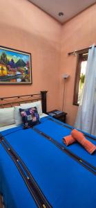 a large blue bed in a room with at Hotel Casa Sofia in Antigua Guatemala