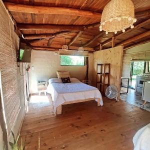 a bedroom with a bed in a room with wooden ceilings at El Silencio 2 - Quebrada - Lozano - Yala - Jujuy in Lozano