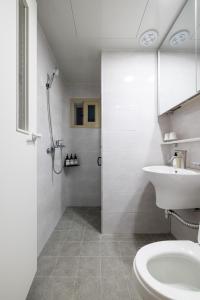 a bathroom with a toilet and a sink and a shower at Choi's Stay HongDae in Seoul