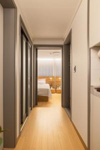 a corridor of a hotel room with a bed at Choi's Stay HongDae in Seoul