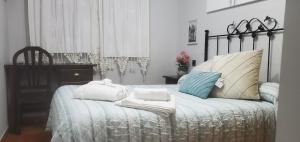 a bedroom with a bed with towels on it at ThE MATADOR in Mocejón
