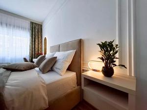 a bedroom with a bed with a potted plant on it at Monte Relax - Wellness Oase in Zlatibor +36 photos