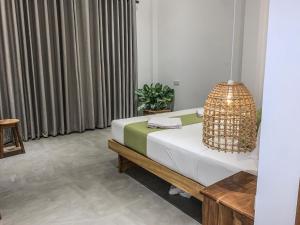 a bedroom with a bed and a pendant light at Summer Time Hiriketiya in Dickwella +122 photos