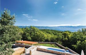 a villa with a swimming pool and a view at Awesome Home In Krk With Wifi in Risika