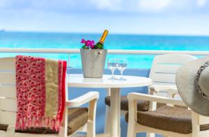 a table with a bottle of wine and two glasses at La Vista Resort in Simpson Bay