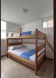 a bedroom with two bunk beds in a room at Villeta Familiar in Villeta