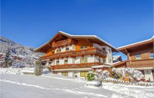 a large building with snow in front of it at Schoene Ferienwohnung-Aschau in Aschau