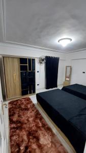 a bedroom with a bed and a rug at Stanley 45 in Alexandria
