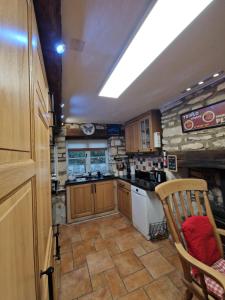 a small kitchen with a stove and a sink at Half-pint Cottage in Stroud