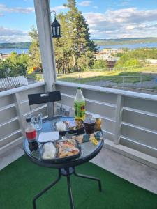 a tray of food on a table on a porch at Room In Handsome Haven House in Gjøvik