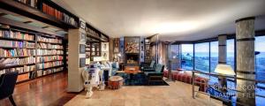 a library with bookshelves and a living room with a fireplace at Marbella Boutique Art suites in Marbella