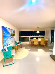 a living room with a large painting on the wall at Apto NOVO BEIRA MAR Praia do Morro vista mar e montanha com 120m 3 qtos Ed Elegance limitado a 8 hóspedes independente da idade in Guarapari