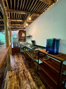 a kitchen with a counter and a fish tank on a table at Alojamiento Natural La Cueva de Morgan San Rafael in San Rafael