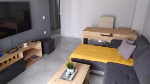 a small living room with a couch and a television at Modern & Charming Mitilini in Mytilene