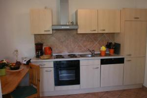 a kitchen with a sink and a stove top oven at Ferienhaus "Kleiner Schoner" in Rerik +3 photos