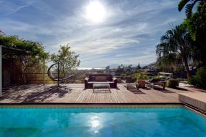 a swimming pool with a deck and a patio at Marbella Boutique Art suites in Marbella