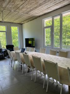 a conference room with a large table and chairs at Rcheuli Villa in Charnali in Batumi