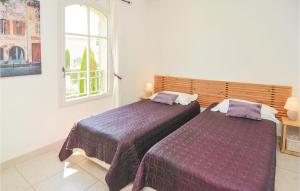 a bedroom with two beds and a window at Amazing Home In Saint Remy De Provence in Saint-Rémy-de-Provence +26 photos