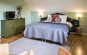 a bedroom with a large bed and a dresser at Lovely Home In Ovezande With Sauna in Ovezande