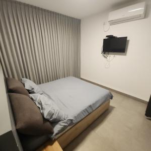 Postel nebo postele na pokoji v ubytování בית אורן - בית דירות - בית שאן