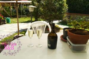 a table with two glasses and a bottle of wine at BeB Villa Licia Appartamento in Villa Basilica
