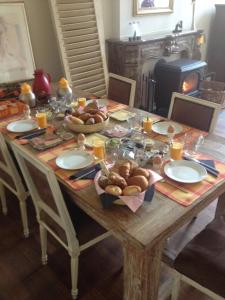 a wooden table with plates of food on it at De Oude Haven in Zierikzee